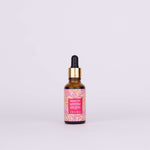 Kesaradi Daily Glow Oil: the amber dropper bottle with a gold collar and a pink flower-print label, on a white background. Label: Kesaradi Oil. Ayurveda's skin brightening, revitalizing, uber-nourishing secret. A signature blend of precious saffron + rose + turmeric + 16 Ayurvedic herbs. iYURA
